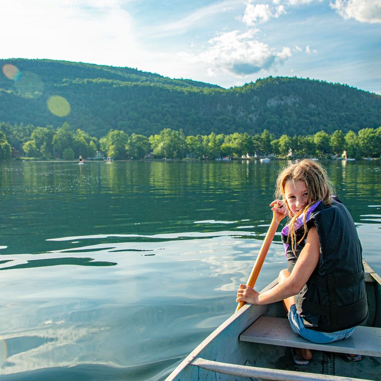 child canoeing on Lake St. Catherine